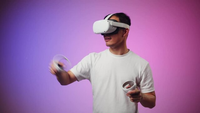 Korean man using virtual reality glasses, playing video games, Asian guy wearing new generation gaming headset for entertainment, amusement park, future technology concept.