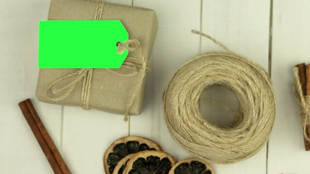 Box with twine and tag, background with copy space. Chroma key. Christmas card. View from above. Copy space - image. Camera zoom