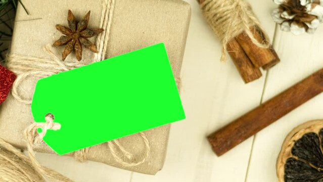 Box with twine and tag, background with copy space. Chroma key. Christmas card. View from above. Copy space - image. Camera zoom
