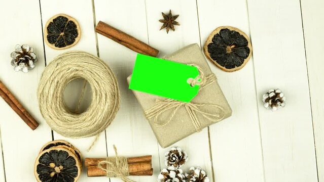 Box with twine and tag, background with copy space. Chroma key. Christmas card. View from above. Copy space - image. Camera zoom