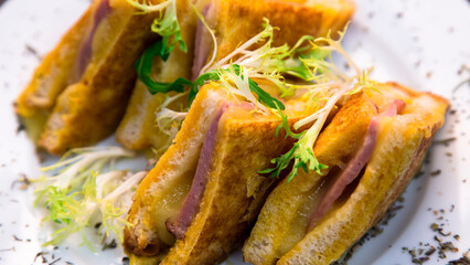 Sandwich fried in egg with ham and cheese. Home cooking. Dish for breakfast.
