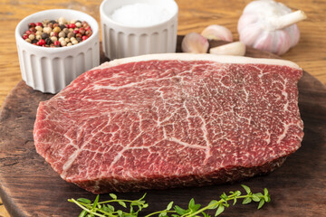 Raw wagyu shoulder roast meat over wooden board with seasonings