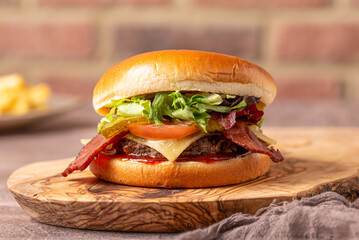 classic bacon cheeseburger on a wooden table