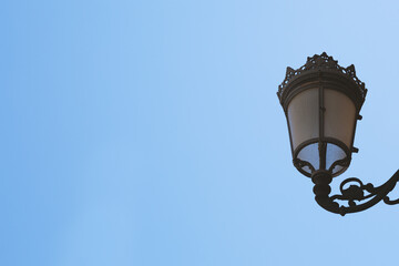 Fototapeta na wymiar old styled street lamp against a clear blue sky