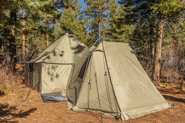 big tent with a vestibule set up in the forest 