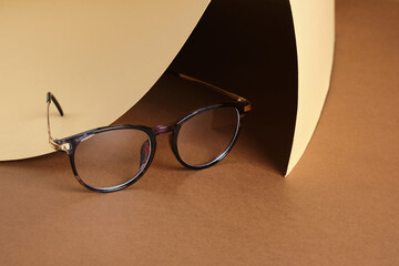 eye glasses on paper brown and beige background, vision concept