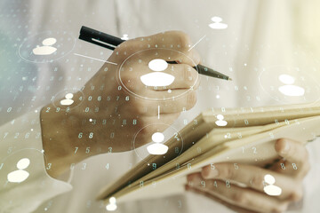 Social network media concept with man hand writing in diary on background. Double exposure