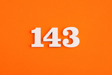 White wooden number 143 on eva rubber orange background
