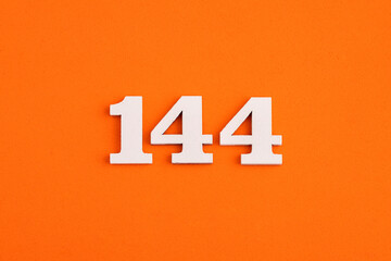 Number 144 - On orange foam rubber background