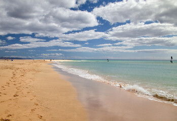 The water edge in the bay of Risco del Paso at cloudy sky