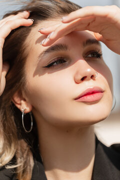 Fresh summer female portrait of beautiful young woman with cute face rest outdoors in sunny day