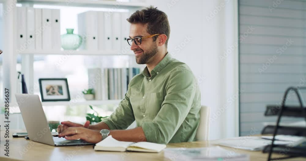 Poster handsome, smiling and happy businessman sitting alone working in his office on a laptop. man thinkin