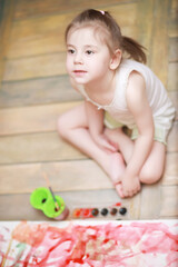 Fototapeta premium Little children paint on a large sheet of paper