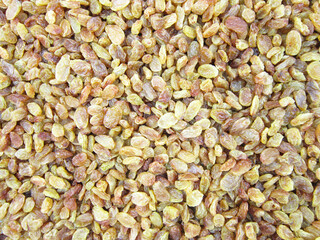       Texture of yellow and orange raisins. Dry raisins on the pile.   