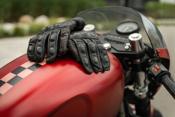 Motorcycle gloves on the fuel tank of the motorcycle