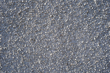 White gray stone exterior wall. It has fine pebbles on it. Suitable background photo.