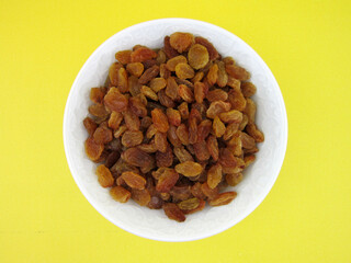        a bowl of yellow golden raisins                    