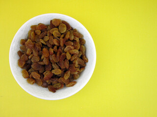    a bowl of yellow golden raisins                     