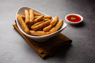 crispy Rava Aloo fingers or Potato semolina fried finger sticks served with ketchup