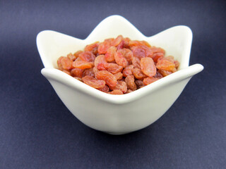    a bowl of yellow golden raisins                     