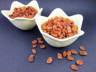 two bowls of yellow golden raisins