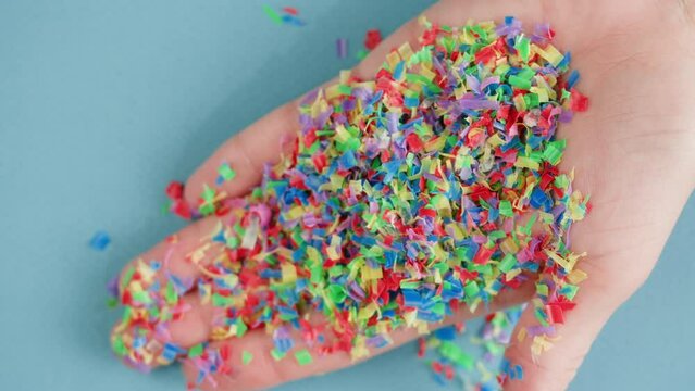 Microplastic pollution, plastic particles in hand close-up, garbage and trash, ecological problems. Global warming and climate changing.