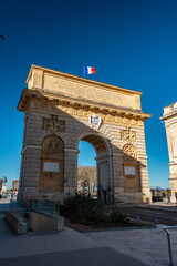 Fototapeta na wymiar street and triumph arch in montpelier france with french flag
