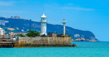 Fototapeta na wymiar Yalta lighthouse in Crimea on the Black Sea at the passenger seaport.