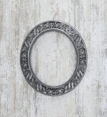 oval vintage frame on old white wooden wall