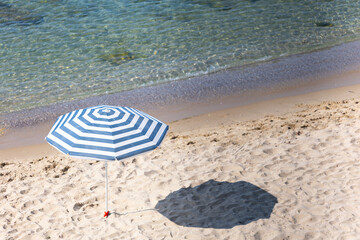 Beach umbrella. Beach, sand and blue sea