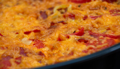 Appetizing delicious pizza in a frying pan. Dish with tomato and cheese. Italian food. Closeup photo