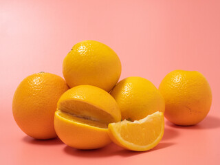 Orange and orange slice. Orange on a pink background.