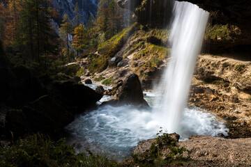Fototapeta na wymiar The Small Perinik Waterfall in Vrata Valley from Hiking Trail Footpath Under It, Triglav National Park Slovenia