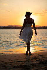 silhouette of a person on the beach at sunset