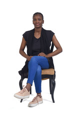 full portrait of a serious woman sitting on chair cross-legged over white background