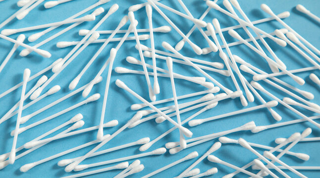 Cotton buds or swabs for ear cleaning on the blue background.