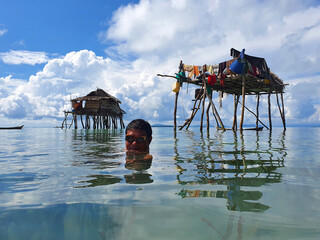 Bajau laut or sea gypsy fishermen near stilt house in Maiga island Semporna Sabah Malaysia