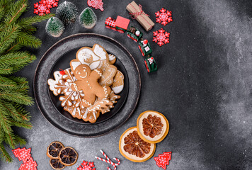 Obraz na płótnie Canvas Gingerbread, Christmas tree decorations, dried citrus fruits on a gray concrete background