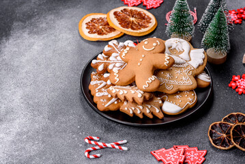 Gingerbread, Christmas tree decorations, dried citrus fruits on a gray concrete background