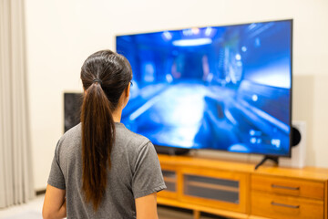 Woman play TV video game at home