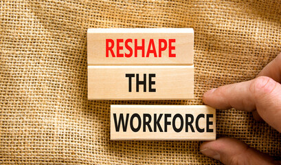Reshape the workforce and support symbol. Concept words Reshape the workforce on wooden blocks. Businessman hand. Beautiful canvas background. Business reshape the workforce quote concept. Copy space