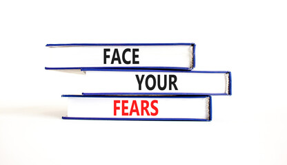 Face your fears and support symbol. Concept words Face your fears on books. Beautiful white table white background. Business and Face your fears quote concept. Copy space.