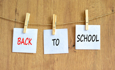 Back to school and support symbol. Concept words Back to school on white papers on wooden...