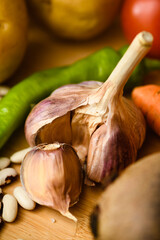 Close-up of young, fresh garlic on a wooden cutting board.