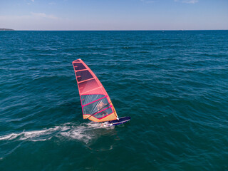 skiing windsurfing in the sea at sunset