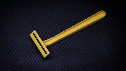 Yellow shaver. Body care tool for shaving isolated on black background