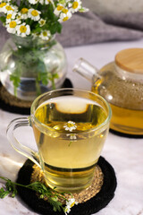 Chamomile tea. Herbal tea. Glass cup with warm fragrant chamomile tea