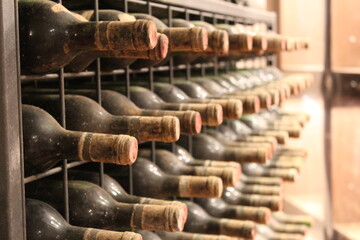 Dusty wine bottles in Italian wine cellar