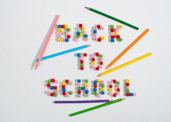Composition of number beads forming words Back To School and pencils.