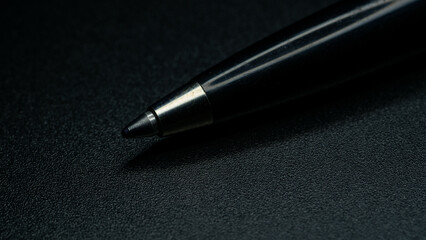 pen on black background 